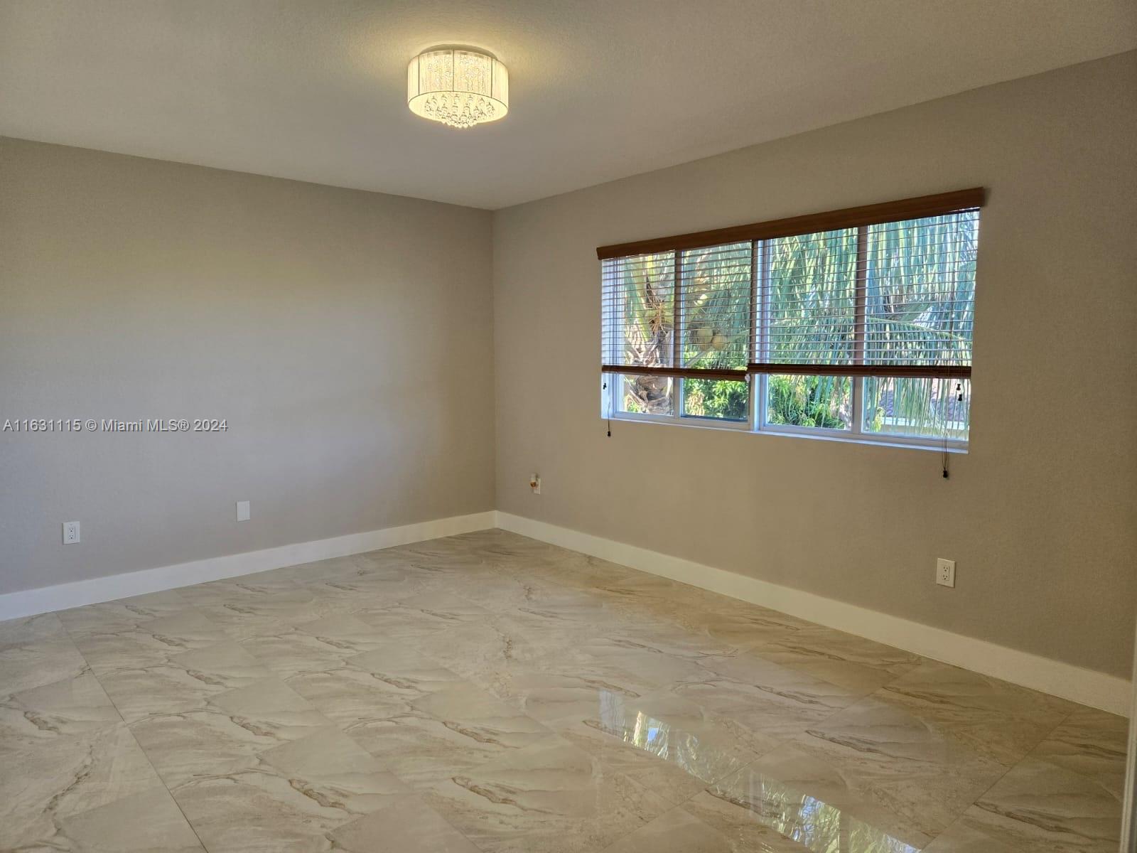 28407 Southwest 129th Place Homestead, FL 33033 - Photo 8 of 17 an empty room with a window