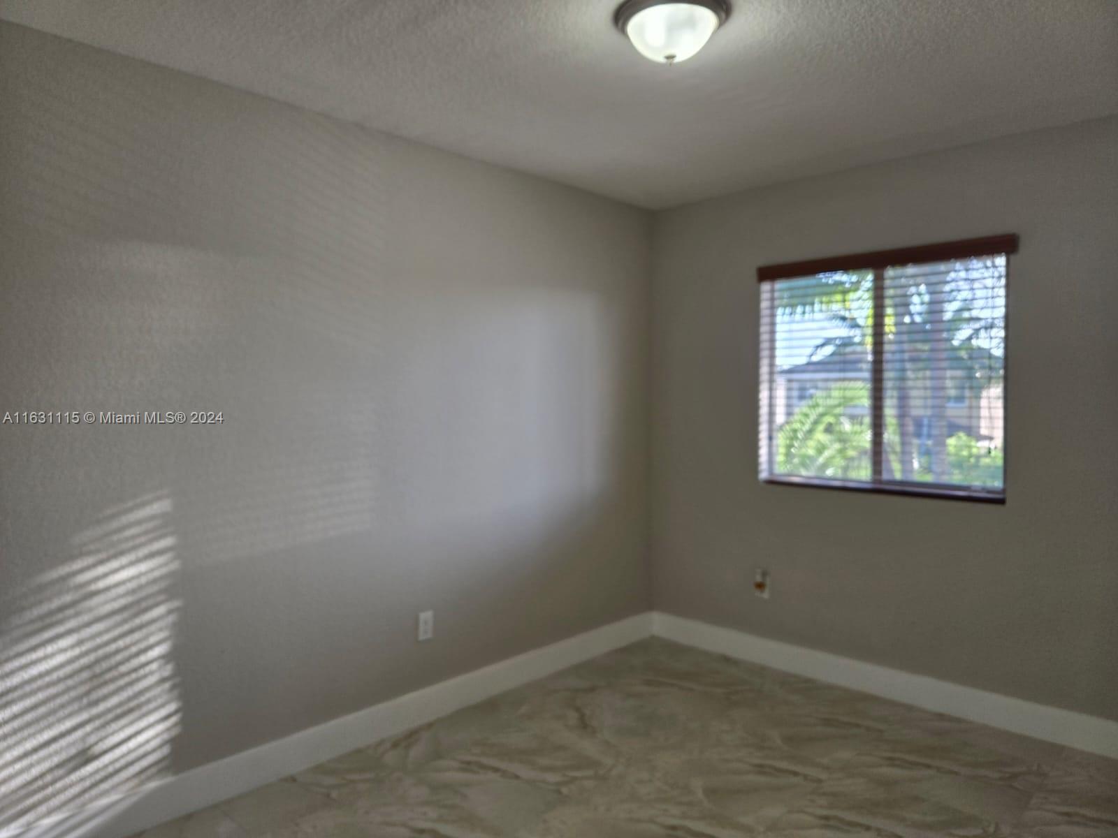 28407 Southwest 129th Place Homestead, FL 33033 - Photo 9 of 17 an empty room with a window