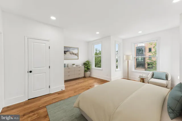 a spacious bedroom with a bed and a couch