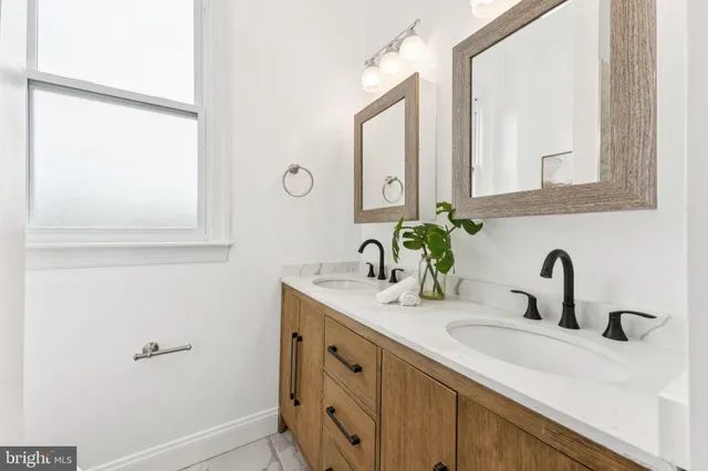 a bathroom with a double vanity sink and a mirror