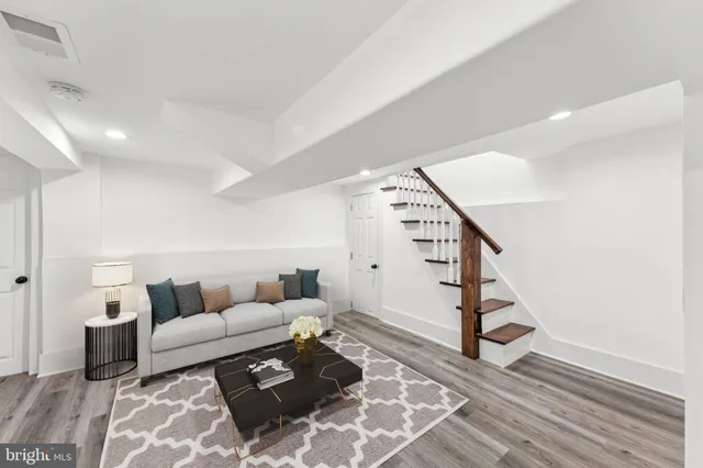 a living room with furniture and stairs