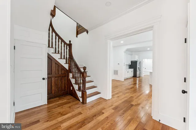 a view of entryway with wooden floor and stairs
