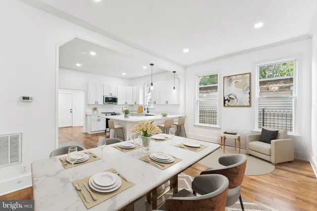 a dining room with furniture and a wooden floor