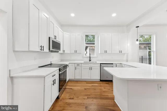 a kitchen with a sink stove and microwave