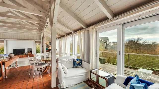 a living room with furniture and a floor to ceiling window