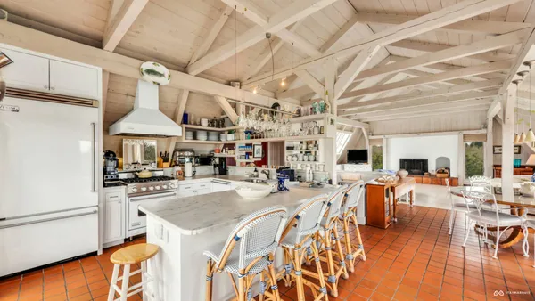 a kitchen with stainless steel appliances granite countertop a sink a stove and refrigerator