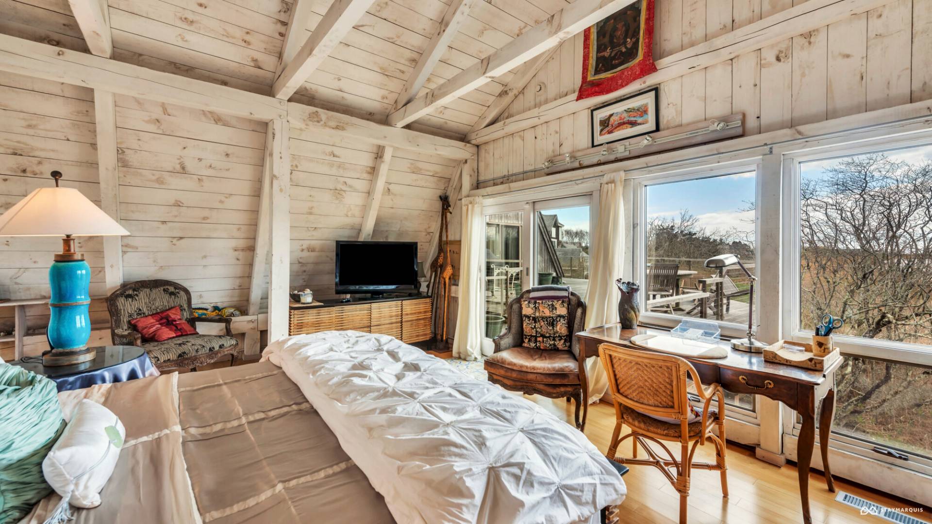 1100 Ocean Road Bridgehampton, NY 11932 - Photo 23 of 49 a bedroom with furniture and a flat screen tv