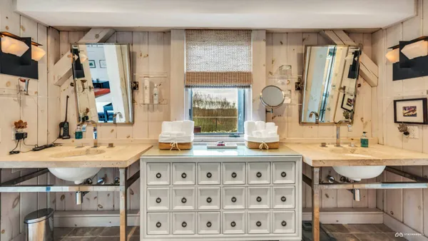 a bathroom with a sink double vanity and a mirror