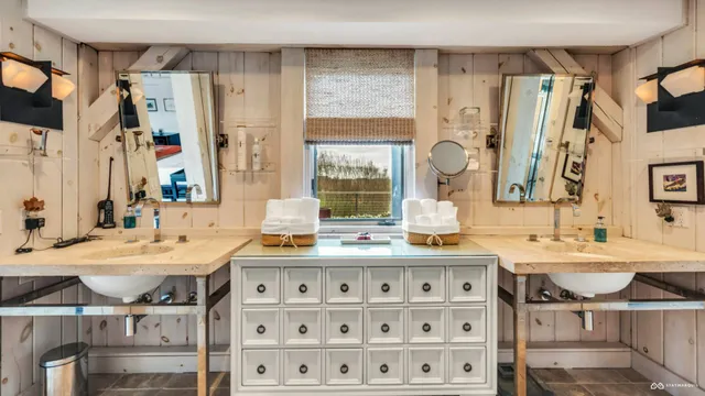 a bathroom with a sink double vanity and a mirror