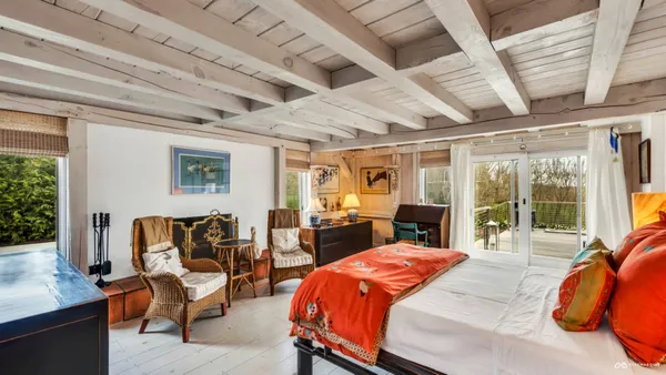 a bedroom with furniture and a window