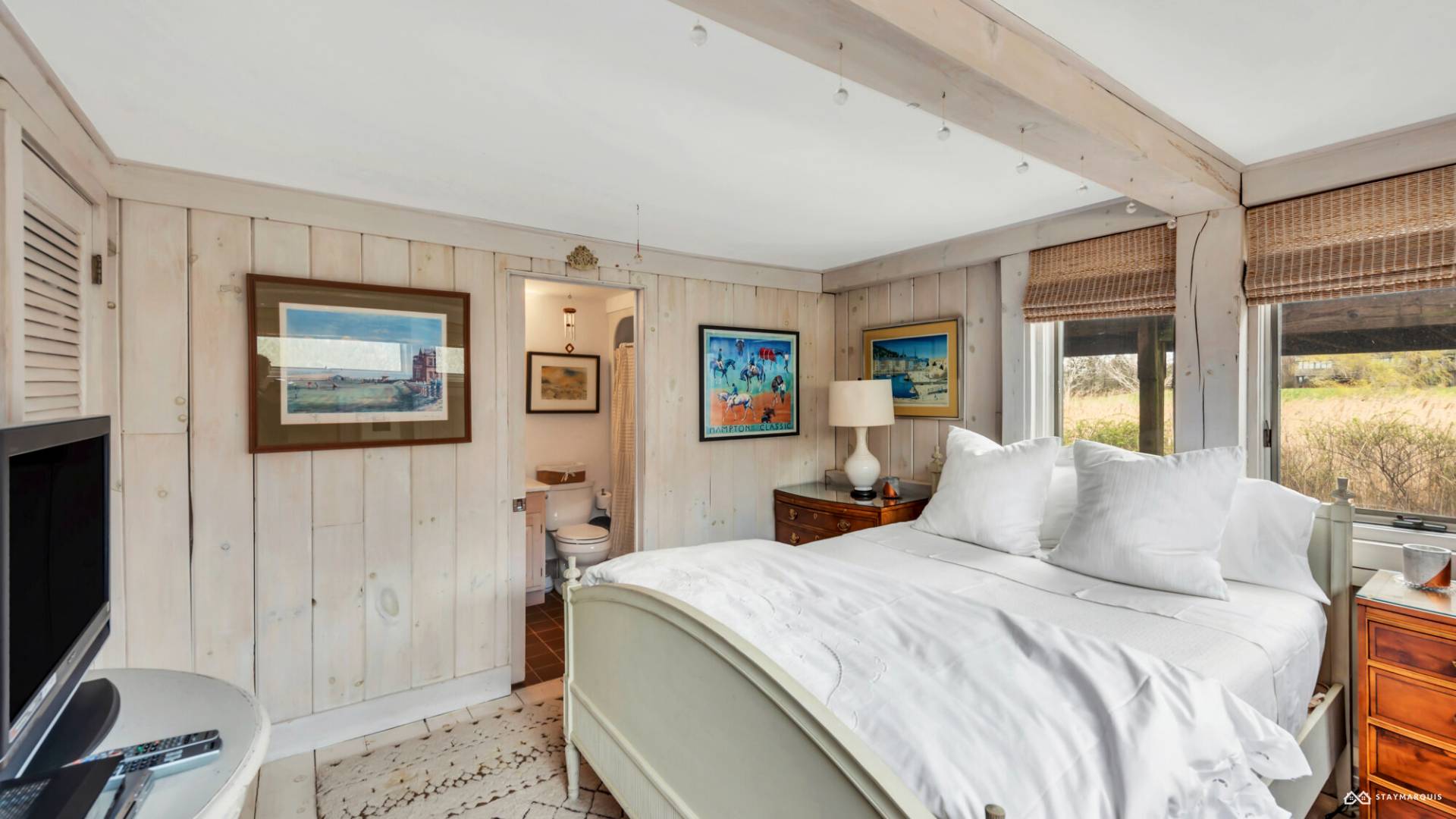 1100 Ocean Road Bridgehampton, NY 11932 - Photo 37 of 49 a bedroom with a bed and a flat screen tv