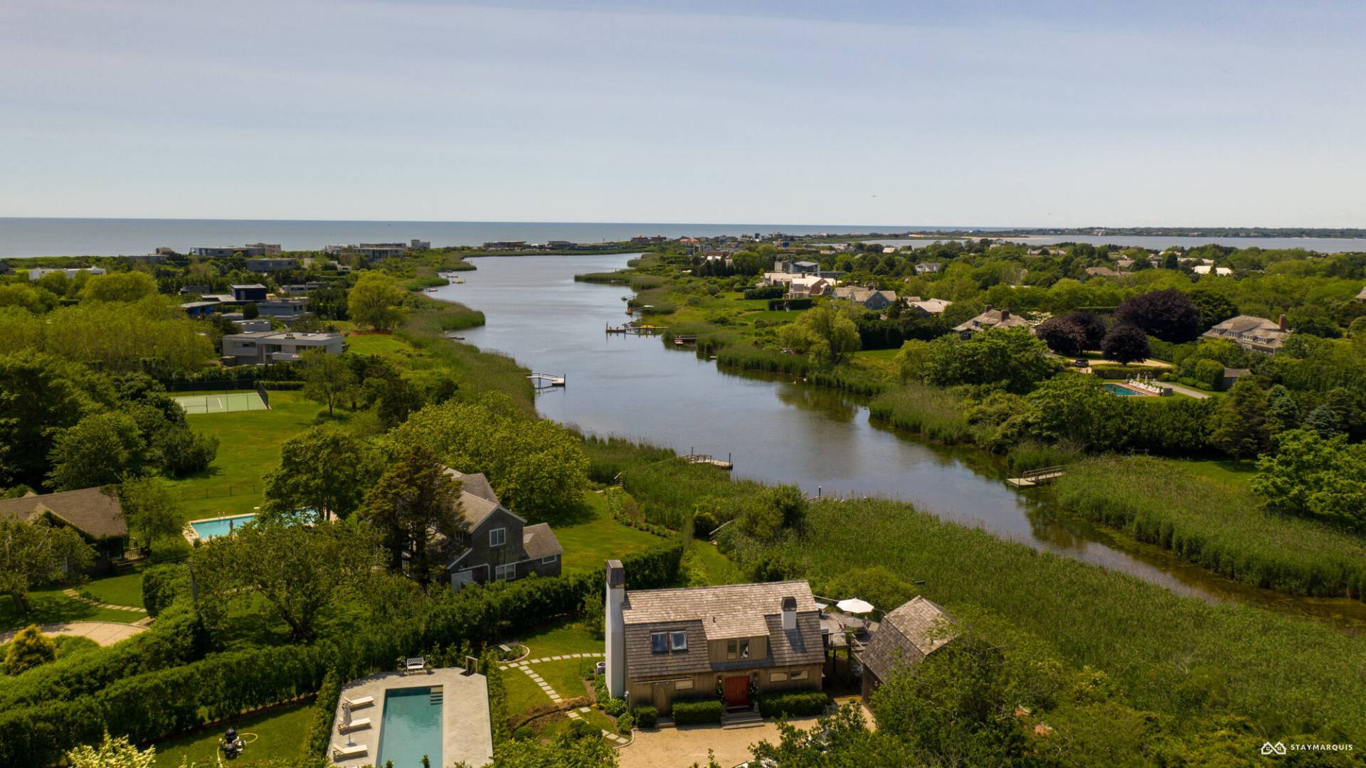 1100 Ocean Road Bridgehampton, NY 11932 - Photo 4 of 49 an aerial view of a house with a yard and lake view
