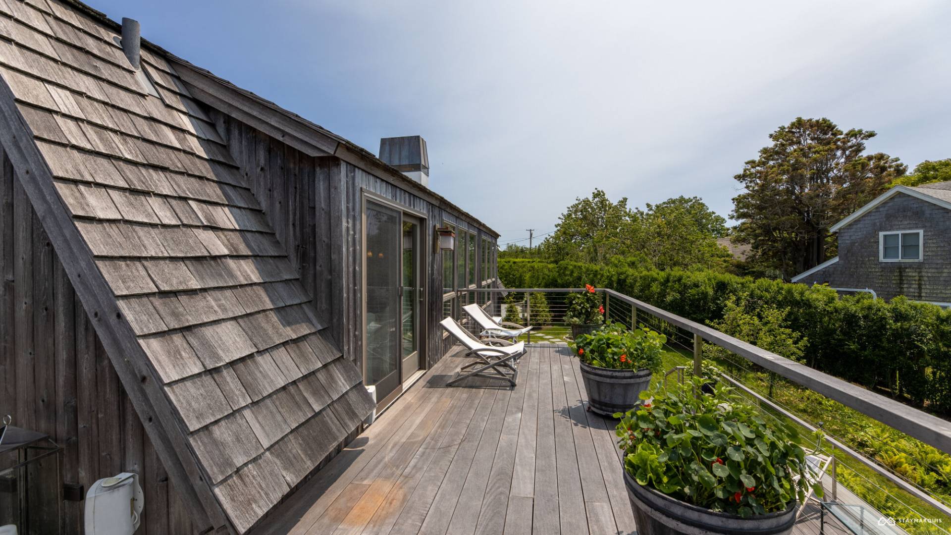 1100 Ocean Road Bridgehampton, NY 11932 - Photo 42 of 49 a balcony with wooden floor stairs and furniture