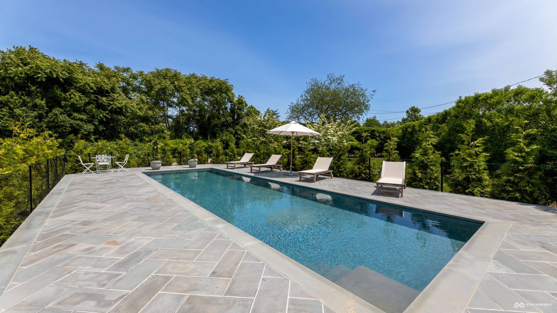 1100 Ocean Road Bridgehampton, NY 11932 - Photo 43 of 49 a view of a swimming pool with a yard