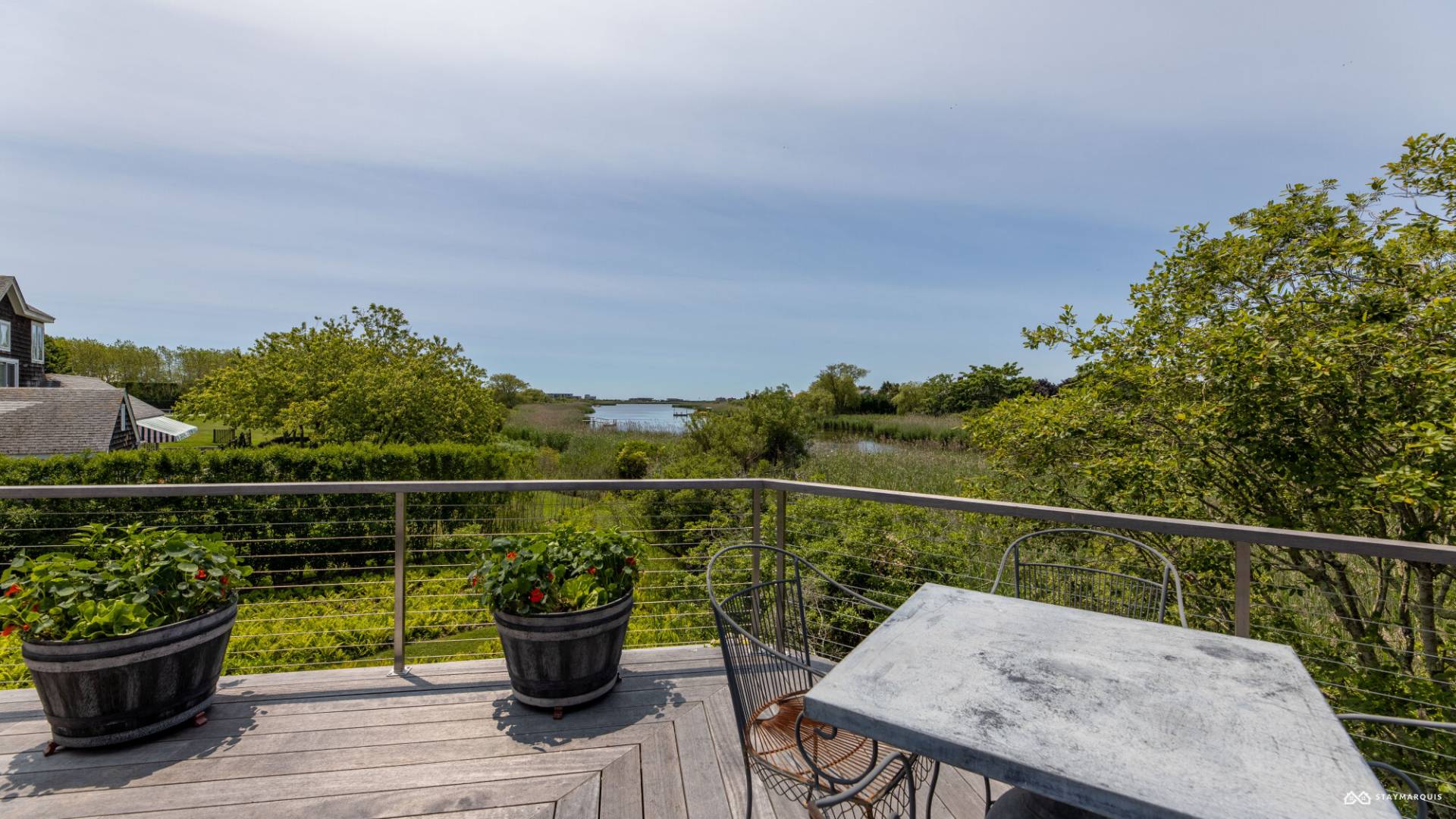 1100 Ocean Road Bridgehampton, NY 11932 - Photo 44 of 49 a view of a balcony with two chairs and a potted plant