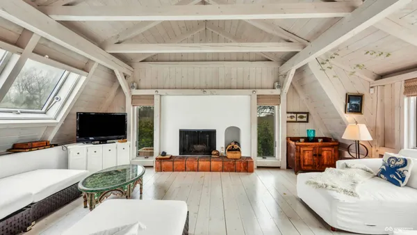 a living room with furniture flat screen tv and a fireplace
