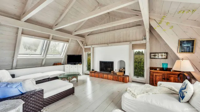 a living room with furniture flat screen tv and a fireplace