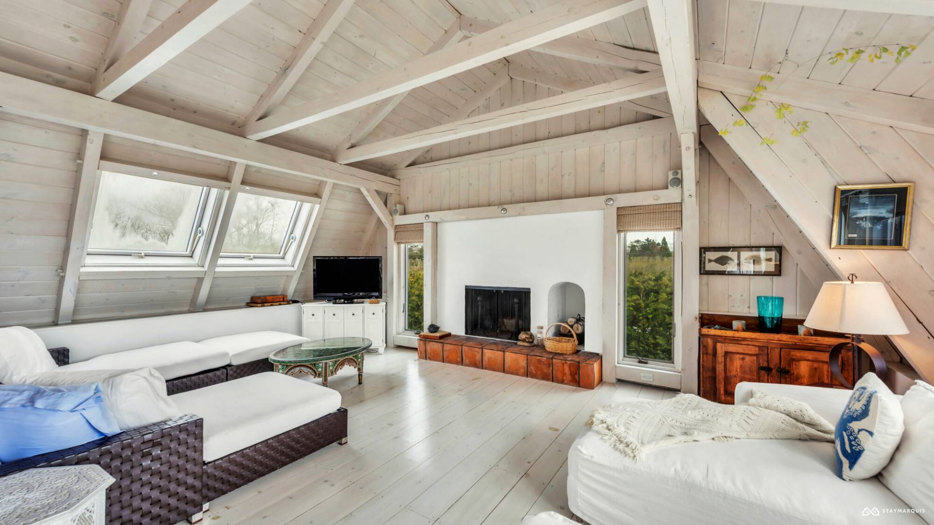 1100 Ocean Road Bridgehampton, NY 11932 - Photo 8 of 49 a living room with furniture flat screen tv and a fireplace