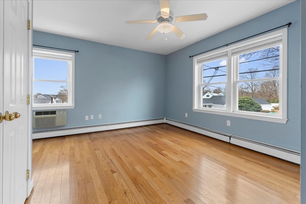 32 Barker Road, Unit 3 Scituate, MA 02066 - Photo 12 of 23 a view of an empty room with a window and wooden floor