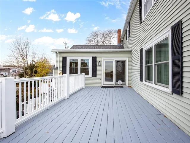 a view of a house with deck and wooden floor