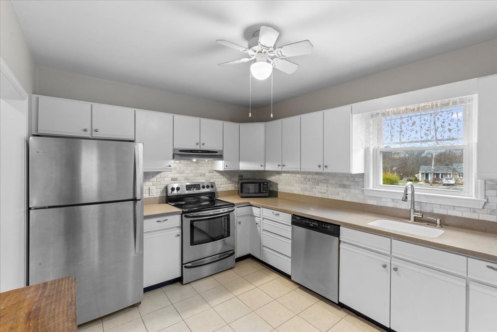 32 Barker Road, Unit 3 Scituate, MA 02066 - Photo 7 of 23 a kitchen with cabinets stainless steel appliances and a window