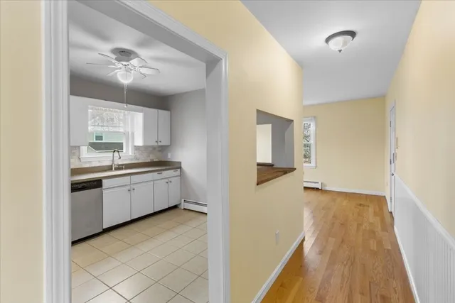 an empty room with windows and fan