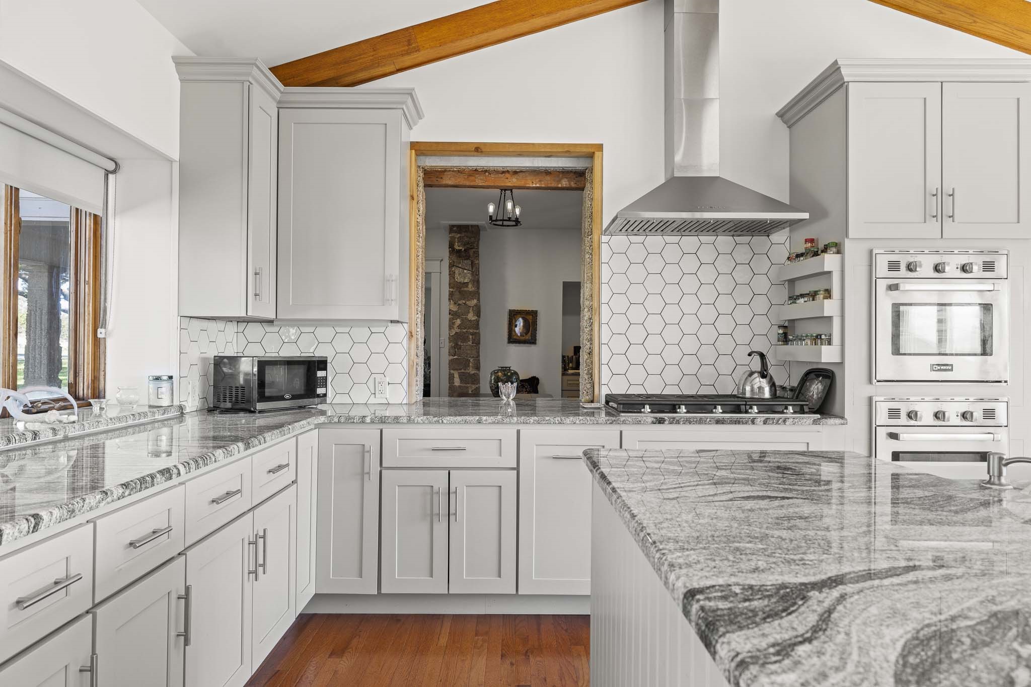 0 Deberry Lane Sonora, TX 76950 - Photo 31 of 50 a large kitchen with granite countertop a sink and cabinets