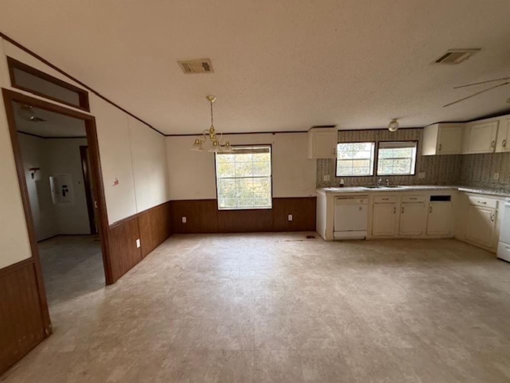 217 Longview Avenue Lady Lake, FL 32159 - Photo 4 of 10 a view of an empty room with window and cabinet area