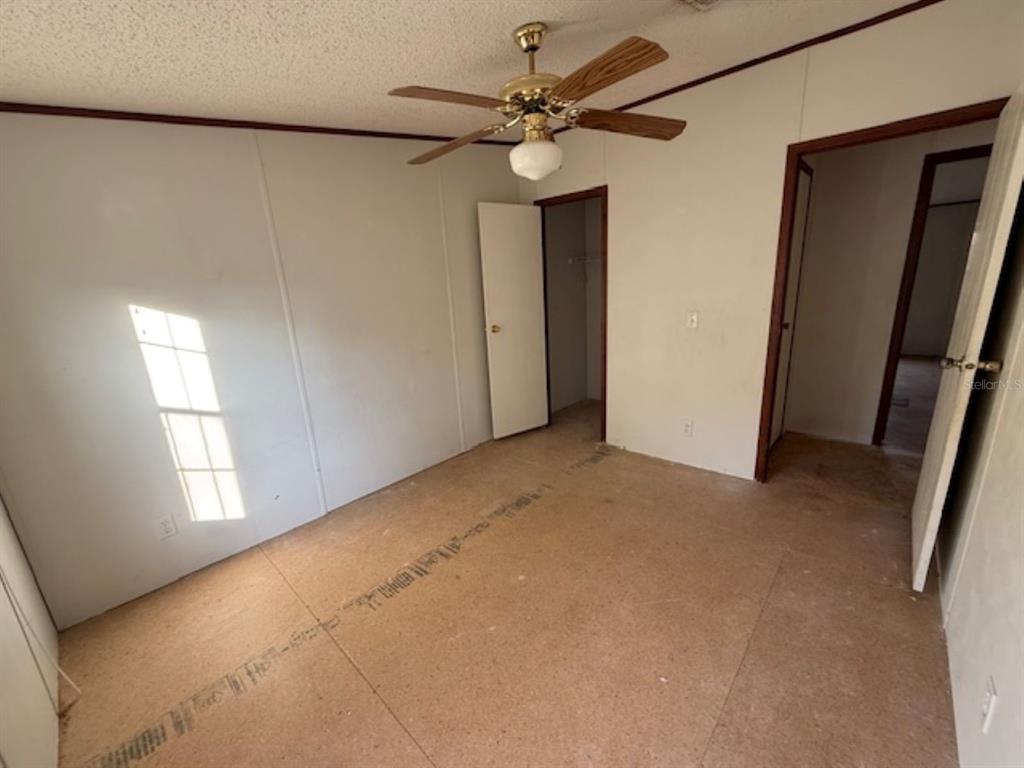 217 Longview Avenue Lady Lake, FL 32159 - Photo 8 of 10 a view of a livingroom with a window and a ceiling fan