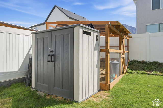 1113 South Raintree Lane Santaquin, UT 84655 - Photo 54 of 59 Plastic storage shed with double doors, wood-framed enclosure, and privacy fencing