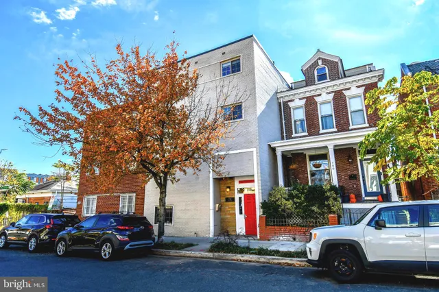 a view of a cars park in front of a building