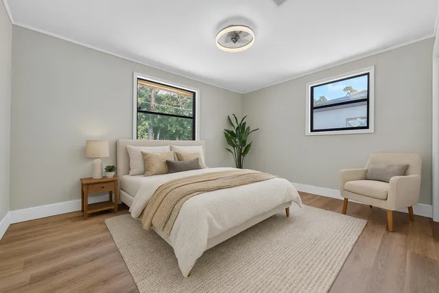 a bedroom with bed and a painting on the wall