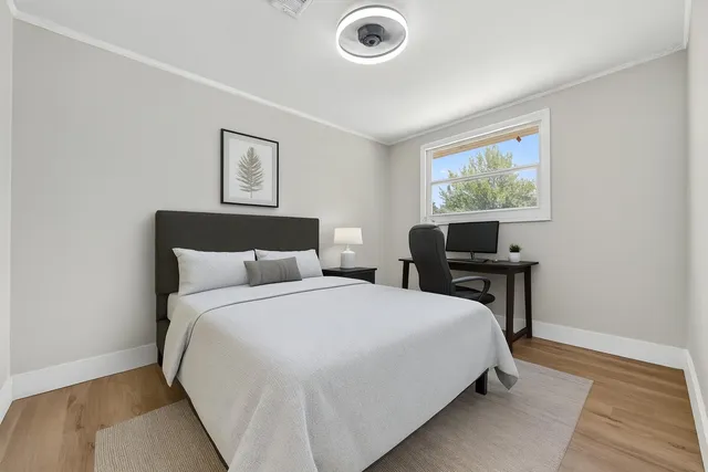 a bedroom with bed and a desk