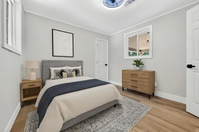 a bedroom with a bed and a painting on the wall