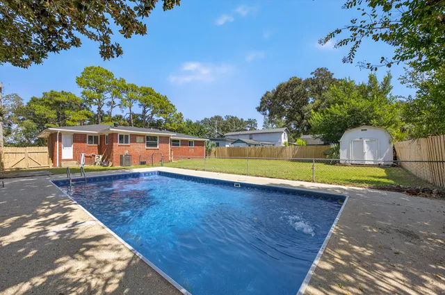 a view of a swimming pool with an outdoor space and seating area
