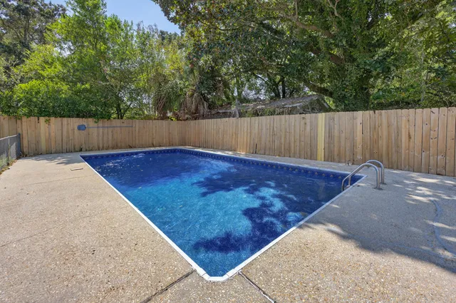 a view of a backyard with wooden fence