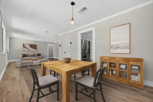 a view of a dining room with furniture window and wooden floor