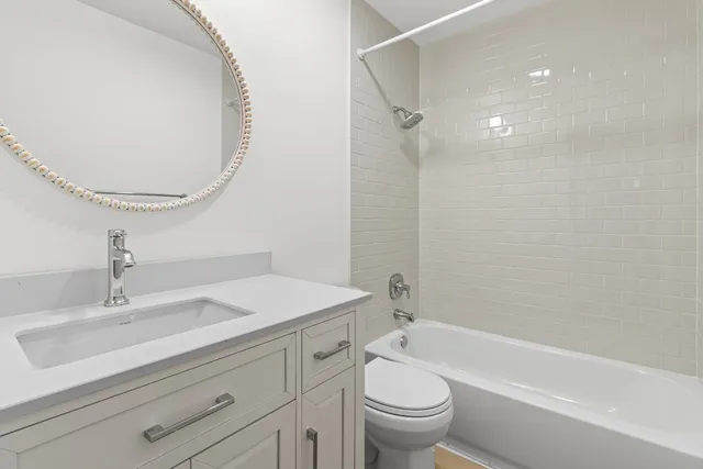 a bathroom with a sink a toilet and a mirror