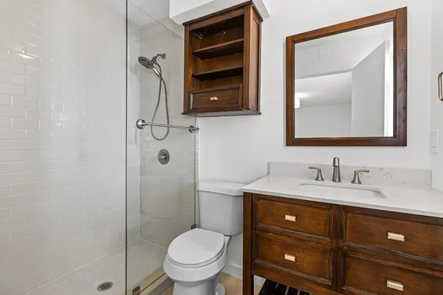 a bathroom with a toilet a sink and mirror
