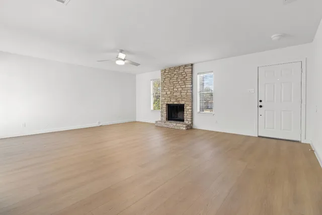 a view of empty room with a fireplace