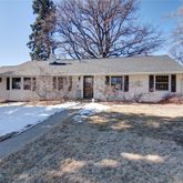 a front view of a house with a yard covered in snow