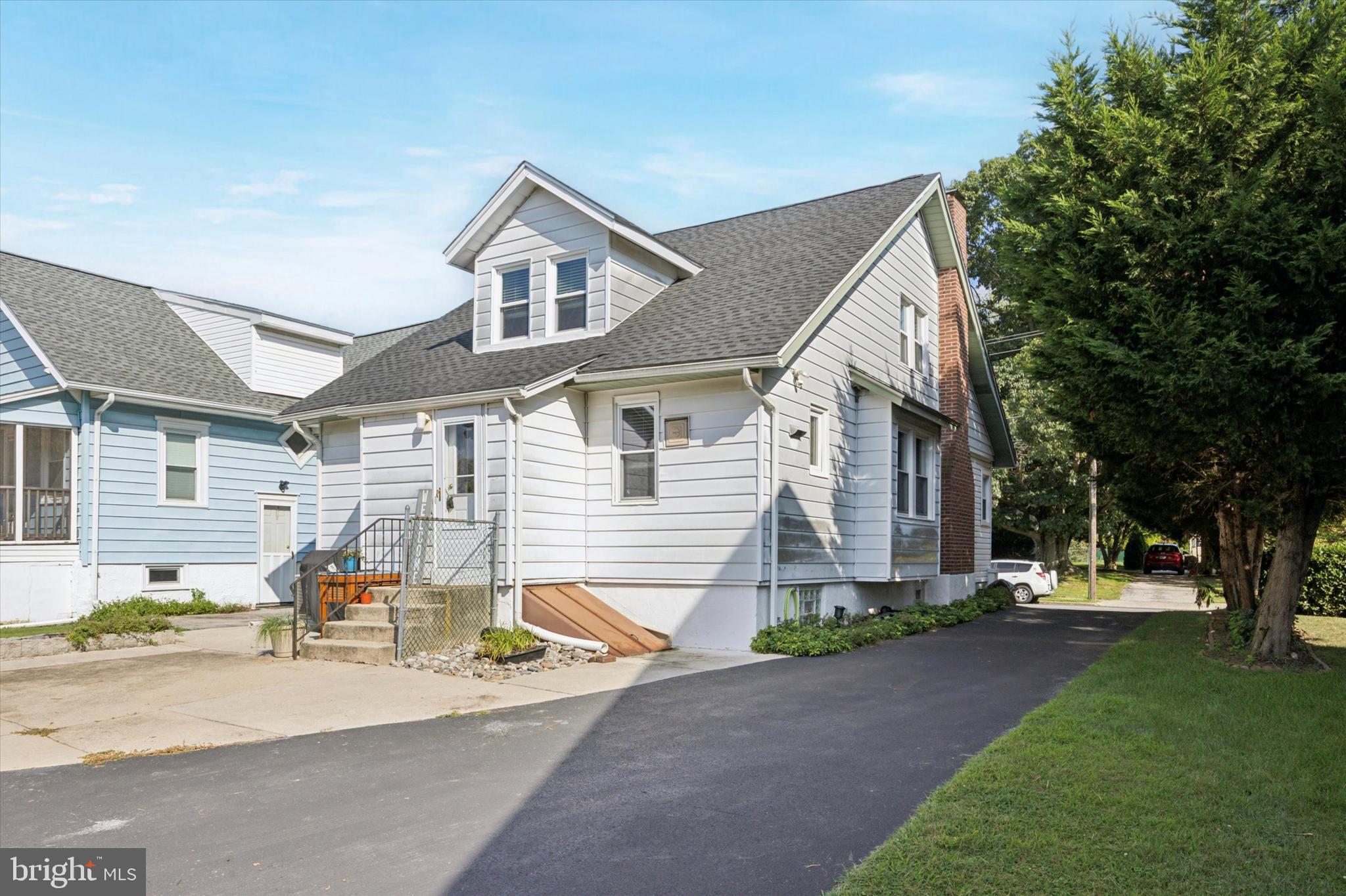 204 Media Line Road Newtown Square, PA 19073 - Photo 14 of 15 a front view of a house with a yard and outdoor seating