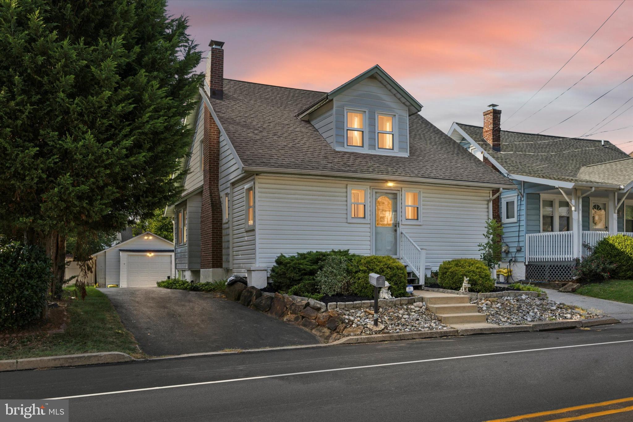 204 Media Line Road Newtown Square, PA 19073 - Photo 2 of 15 a front view of a house with a yard and garage