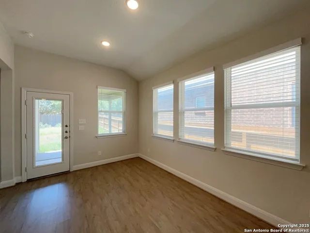 a view of living room with kitchen island stainless steel appliances wooden floor and living room view