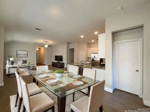 a view of a dining room with furniture and wooden floor