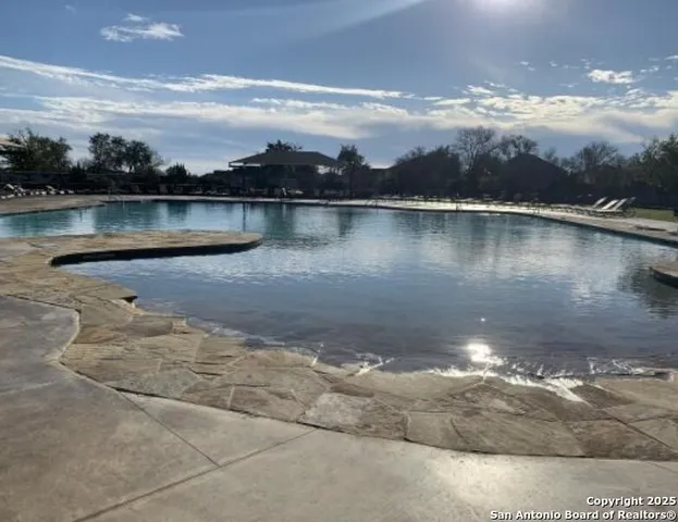 a view of a chairs and table in backyard