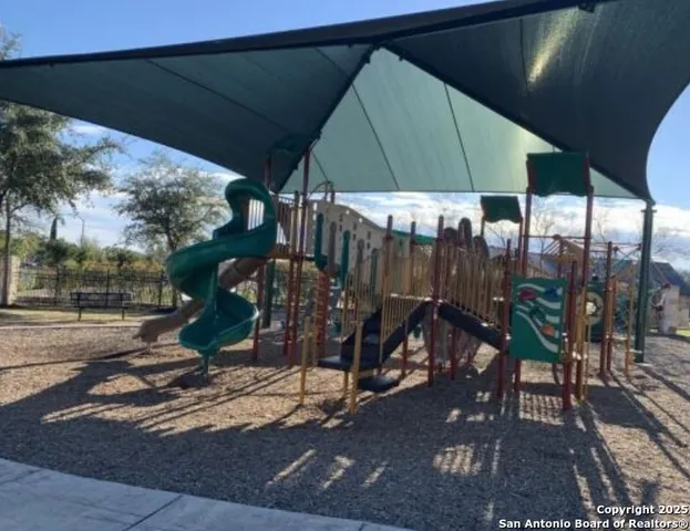a picture of a room with a bench and a wooden floor