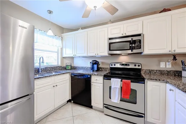 a kitchen with stainless steel appliances granite countertop a stove sink microwave and cabinets