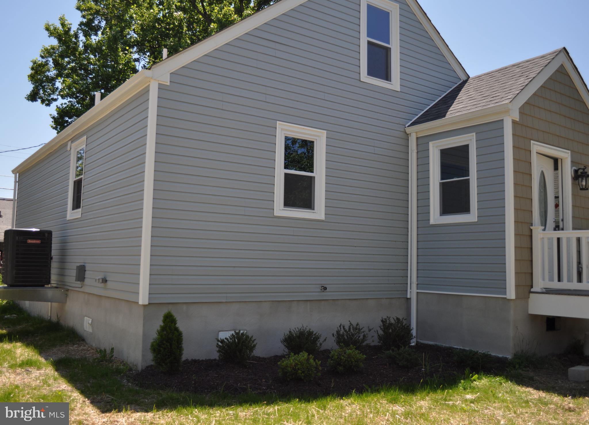 8103 Bullneck Road Baltimore, MD 21222 - Photo 2 of 26 a front view of a house with a yard and garage