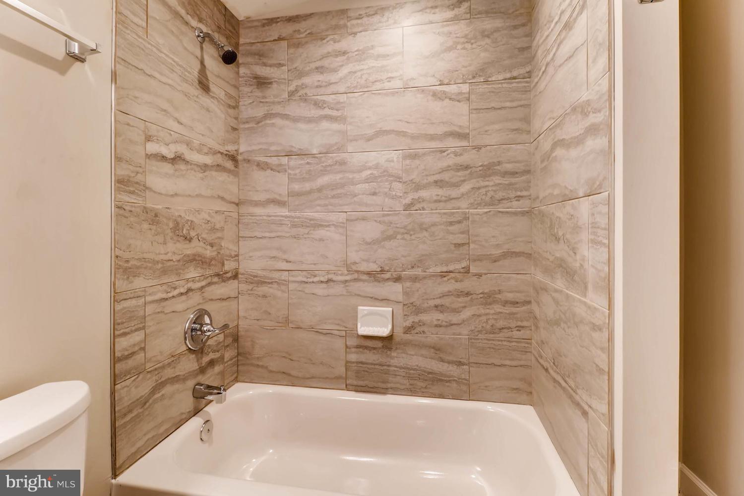 8103 Bullneck Road Baltimore, MD 21222 - Photo 21 of 26 a bathroom with a bathtub and shower